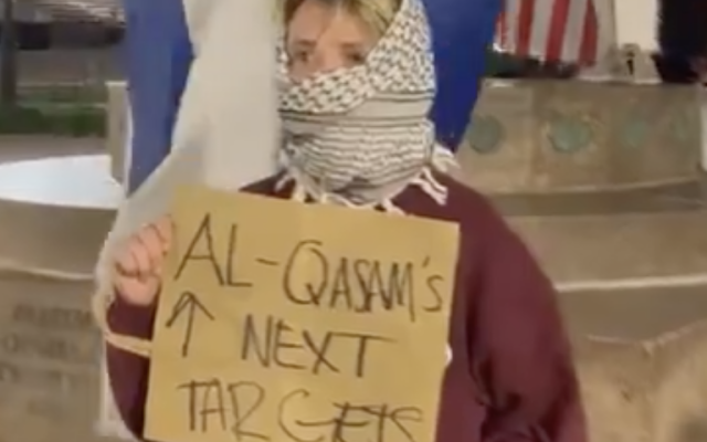 A chilling scene at Columbia: a protestor with face covered paints a target on Jewish peers, ominously invoking the threat of Al-Qassam violence.